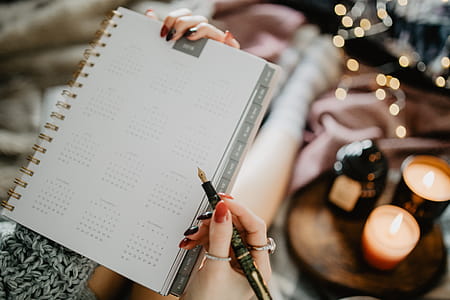 Writing in a notebook lying in bed, with coffee, candles, and gingerbreads thumbnail