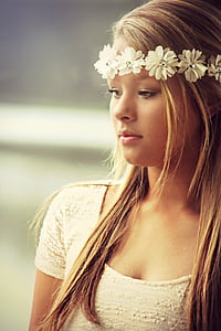 woman in white scoop-neck top wearing white floral hair accessory thumbnail