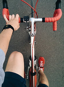 person wearing red New Balance shoes riding on road bicycle thumbnail