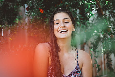 smiling woman closing her eyes at daytime thumbnail