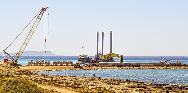 crane beside sea at daytime thumbnail