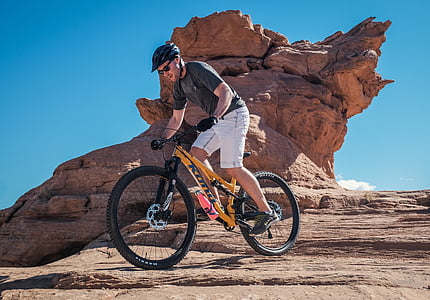 man riding yellow mountain bike thumbnail