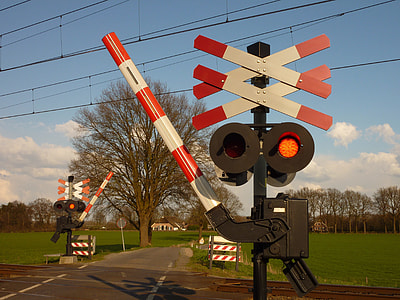 red and white metal train sign at daytime thumbnail