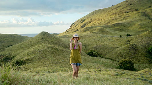 woman standing in grass field thumbnail