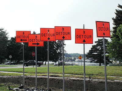 Detour road signage's near green field under white skies thumbnail