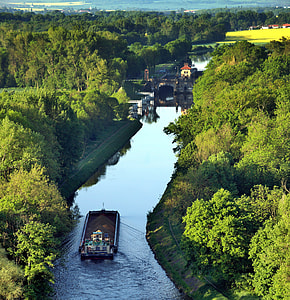 aerial photo of brown boat on river near trees at daytime thumbnail