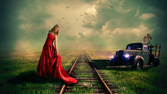 woman in red sleeveless dress standing beside train rail thumbnail