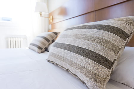 two striped pillows on bed thumbnail