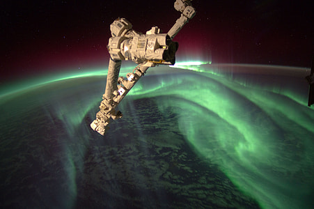 green Aurora borealis under gray spacecraft thumbnail