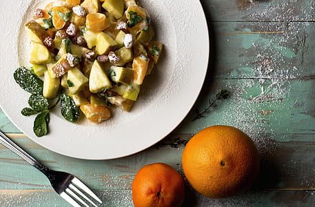 two orange fruits near white ceramic plate thumbnail