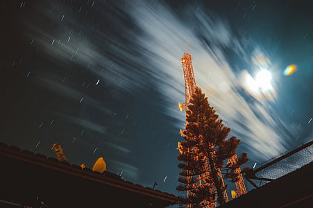 time lapse photography of tower near tree thumbnail