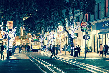 people walking around city street during night time thumbnail