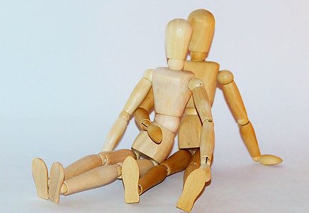 two brown jointed wooden dolls thumbnail