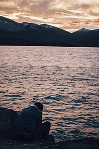 man sitting near sea thumbnail