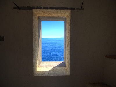 gray concrete window showing body of water thumbnail