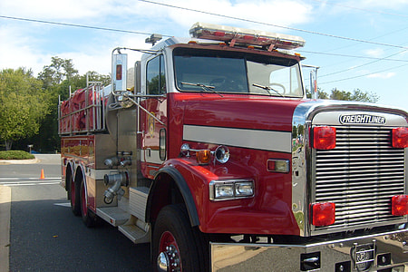 red and white fire truck on parking lot during daytime thumbnail