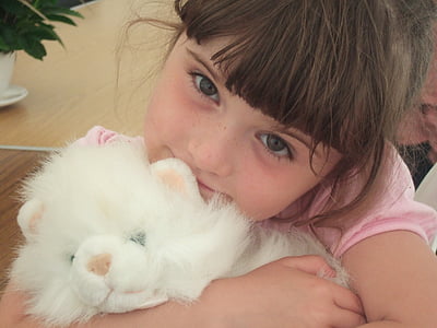 girl wearing pink hugging white cat plush toy thumbnail