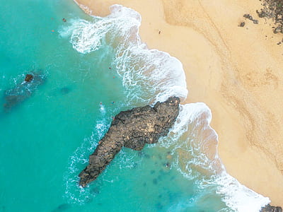 aerial photography of rock formation on seashore thumbnail