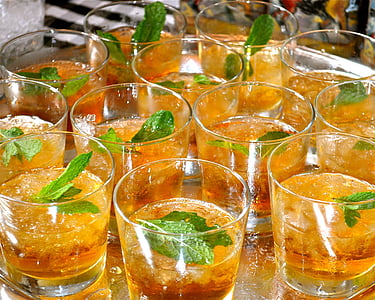 clear shot glasses with yellow liquid drink on gray metal tray thumbnail