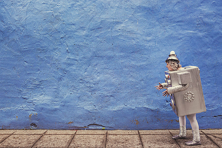 woman in silver robot costume during day time thumbnail