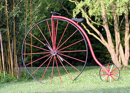 red penny farthing on green grasses thumbnail