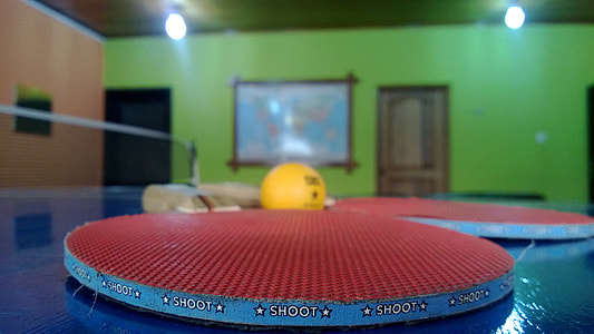 two red ping pong paddles and orange table tennis ball thumbnail