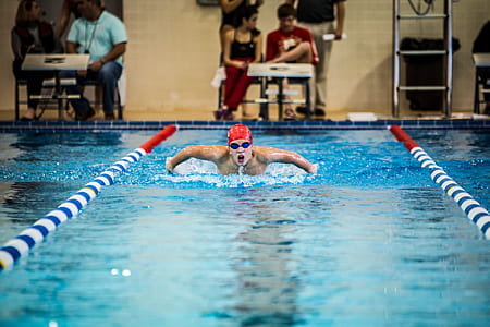 man swimming in pool near people thumbnail