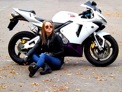 woman sitting on floor beside sports bike thumbnail