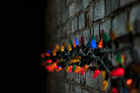 string lights on gray concrete brick wall thumbnail