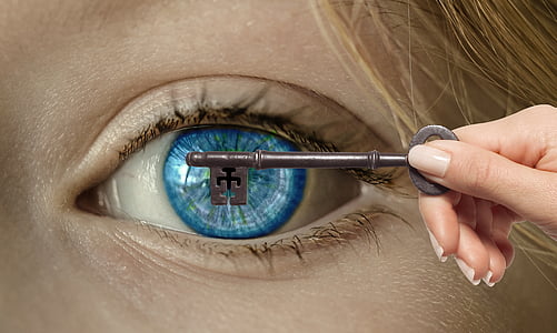 person holding key covering person's left eyeball thumbnail