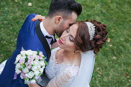 newly wed couple dancing on green grass field during daytime thumbnail