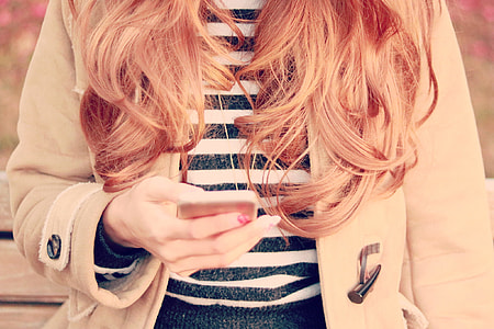 woman holding phone thumbnail