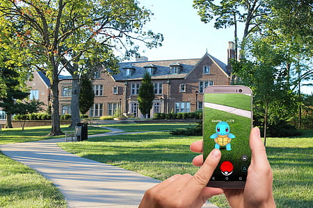 person holding beige Android smartphone playing Pokemon Go! thumbnail