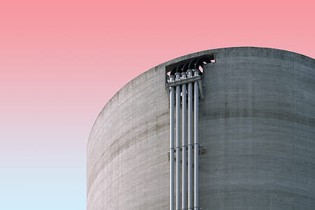 gray metal pipes on gray concrete building thumbnail