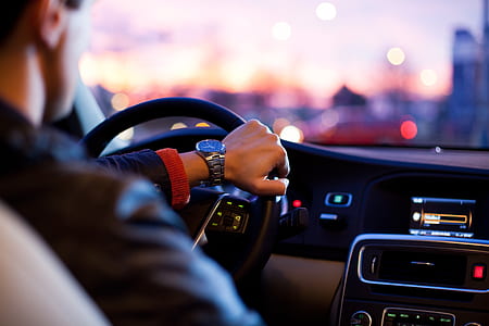 man in black jacket holding steering wheel thumbnail