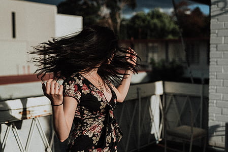 woman wearing black and pink V-neck floral top thumbnail
