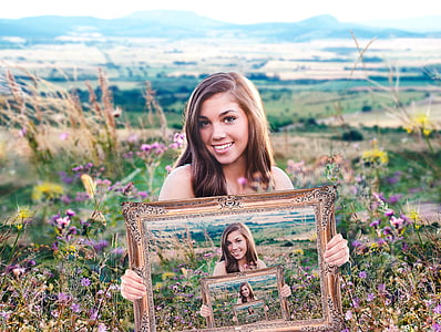 illusion photography of woman holding frame thumbnail