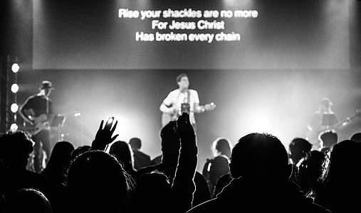 grayscale photography of band performing on stage thumbnail