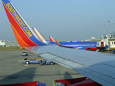 blue and red airplane during daytime thumbnail