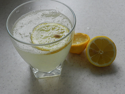 clear glass cup with liquid on white tile thumbnail
