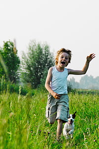 man running in grass field with puppy thumbnail