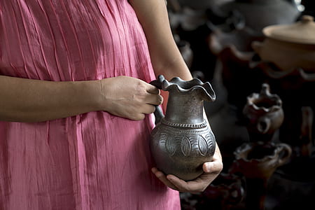 woman holding brown pitcher thumbnail