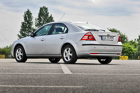 silver sedan parked on gray pavement riad thumbnail