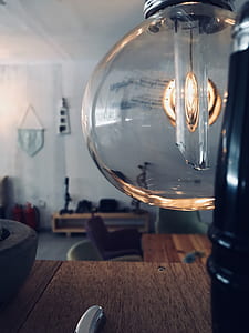 Clear Glass Lamp Near Brown Wooden Surface thumbnail