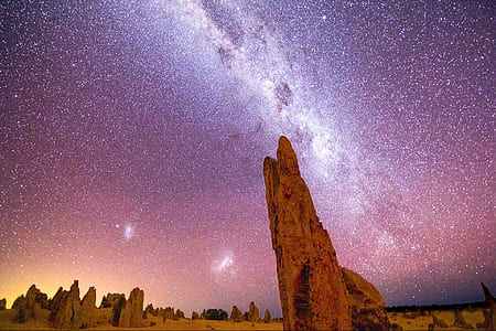 time lapse photograph of rock under starry night thumbnail