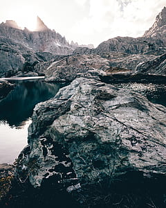 landscape photography of rock formation near body of water thumbnail