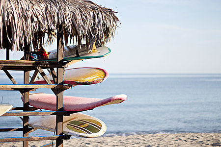 surfboards on brown wooden hut thumbnail