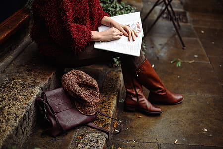 Woman Sitting While Holding Book thumbnail