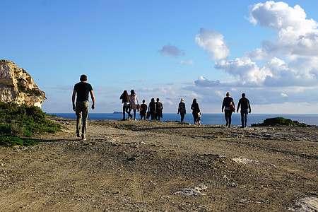people walking on mountain near body of water thumbnail