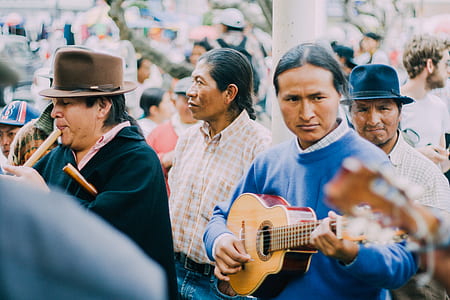 Man Playing Acoustic Guitar Beside People during Daytime thumbnail